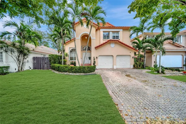 a front view of a house with a garden and yard