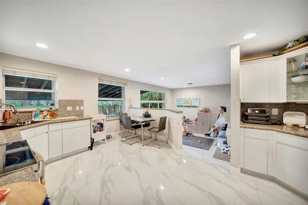 a kitchen with stainless steel appliances granite countertop a refrigerator and a stove top oven