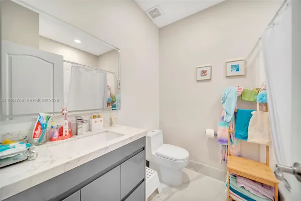 a bedroom with furniture and a book shelf