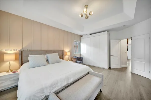 a view of a backyard with potted plants and large trees