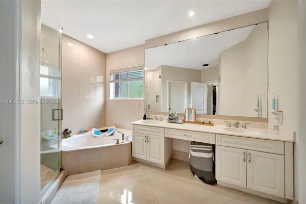 an aerial view of a houses with a yard and lake