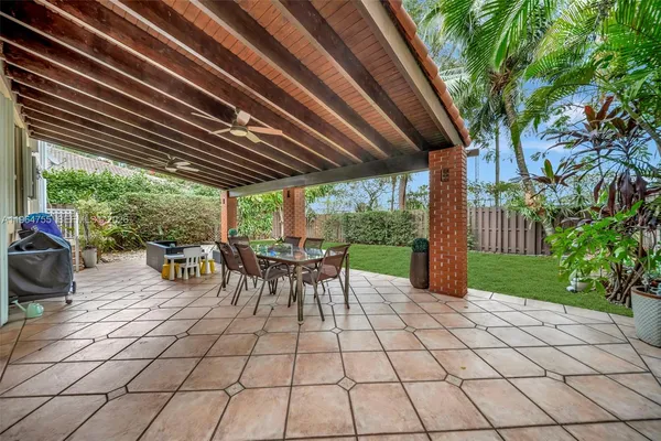 an aerial view of a houses with a yard and lake view