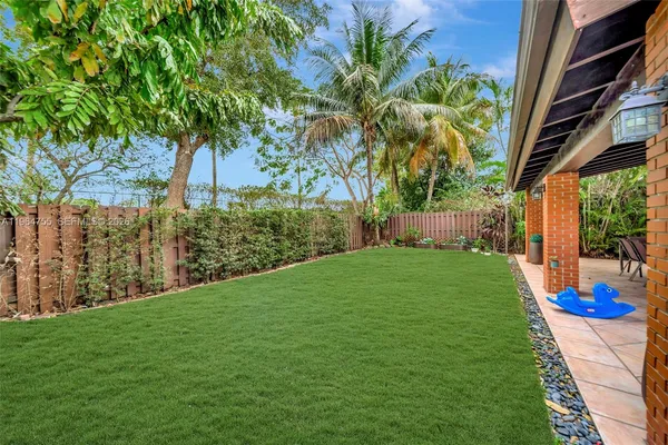 an aerial view of a house with garden space and street view