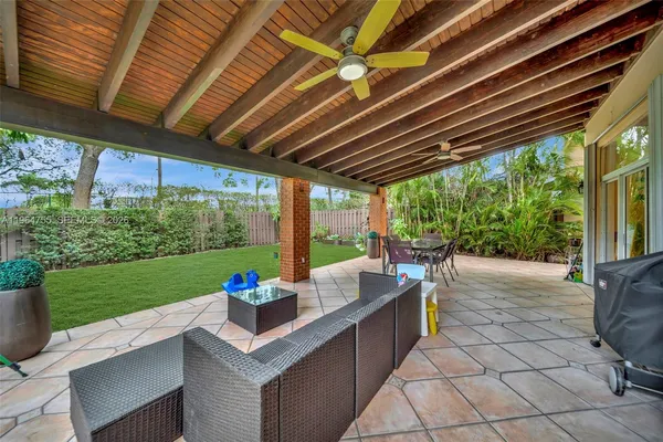 an aerial view of residential houses with outdoor space and swimming pool