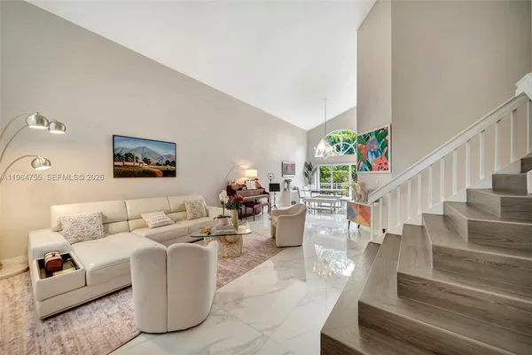 a living room with furniture and a chandelier