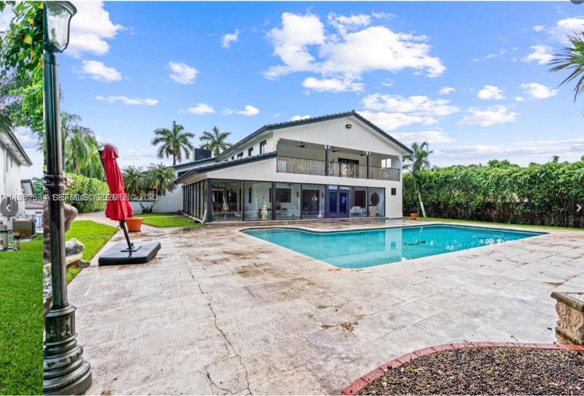 3420 Southwest 129th Avenue Miami, FL 33175 - Photo 2 of 7 a view of a house with a swimming pool and a yard