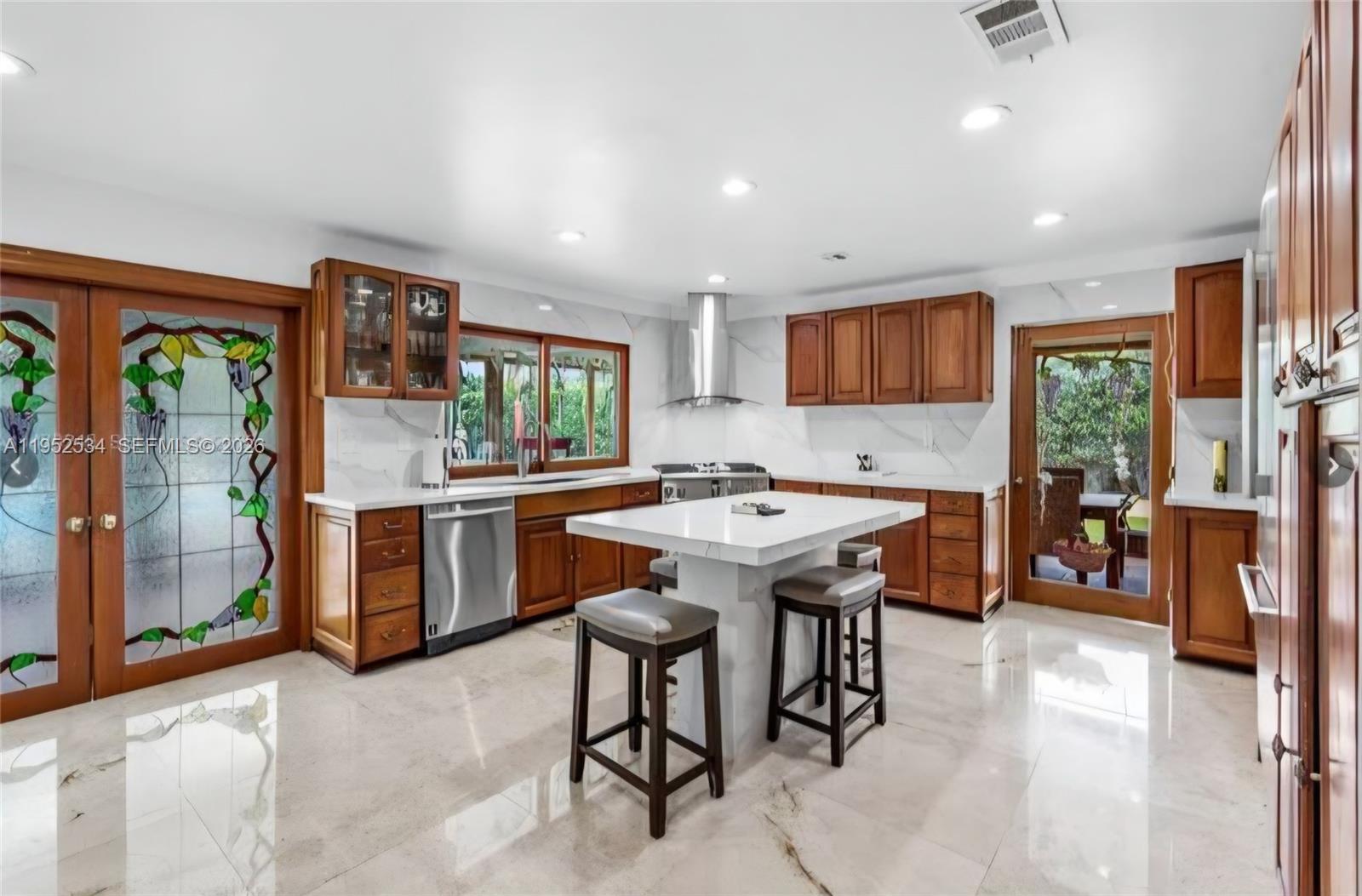 3420 Southwest 129th Avenue Miami, FL 33175 - Photo 6 of 7 a kitchen with a table and chairs in it