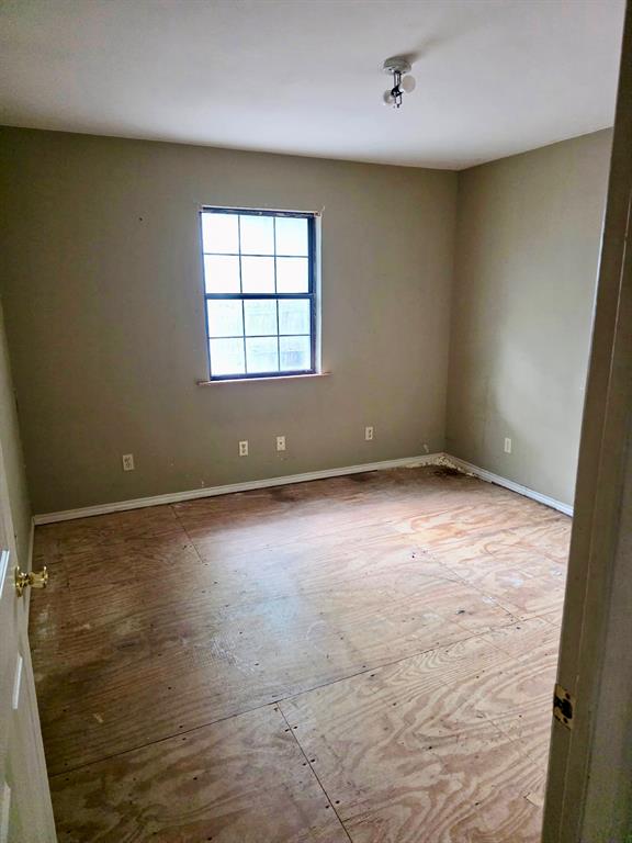 417 West Huffman Street Krum, TX 76249 - Photo 17 of 26 Room featuring a single window, baseboard trim, and a ceiling-mounted light fixture
