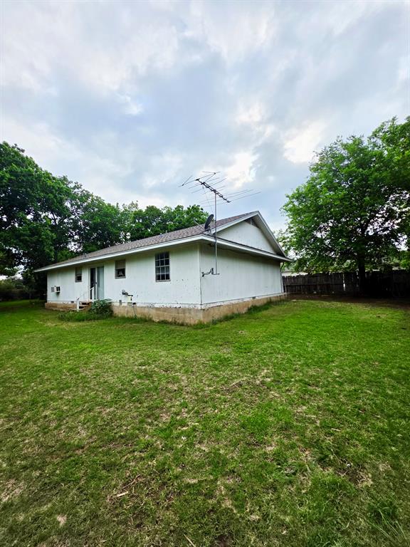 417 West Huffman Street Krum, TX 76249 - Photo 21 of 26 Single-story residence featuring white siding and a light-colored shingle roof