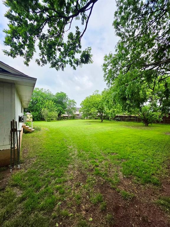 417 West Huffman Street Krum, TX 76249 - Photo 24 of 26 Expansive green lawn with mature trees providing natural shading