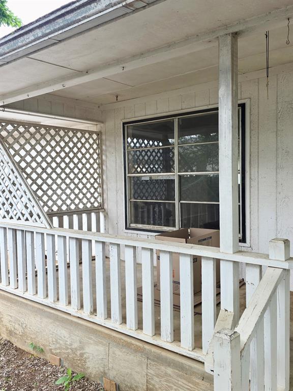 417 West Huffman Street Krum, TX 76249 - Photo 5 of 26 Covered porch with white painted railings and lattice detailing