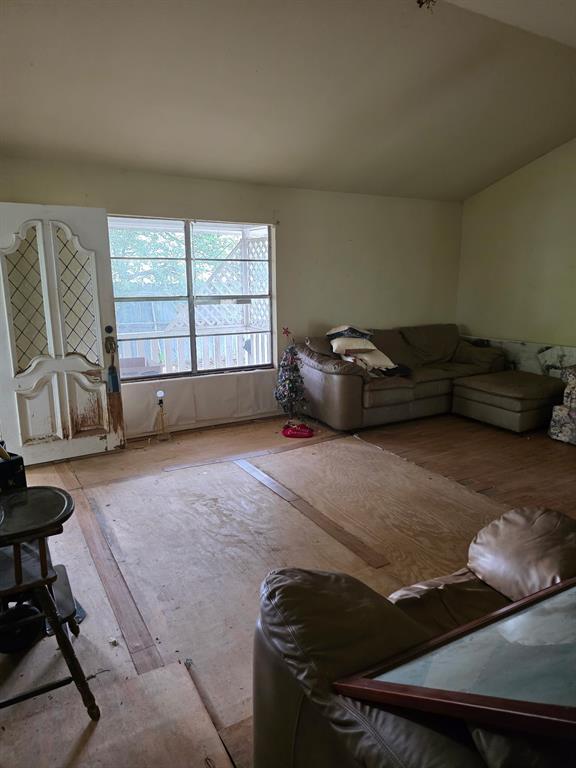417 West Huffman Street Krum, TX 76249 - Photo 8 of 26 Interior space featuring neutral-toned walls, a window overlooking an outdoor area, and exposed subflooring