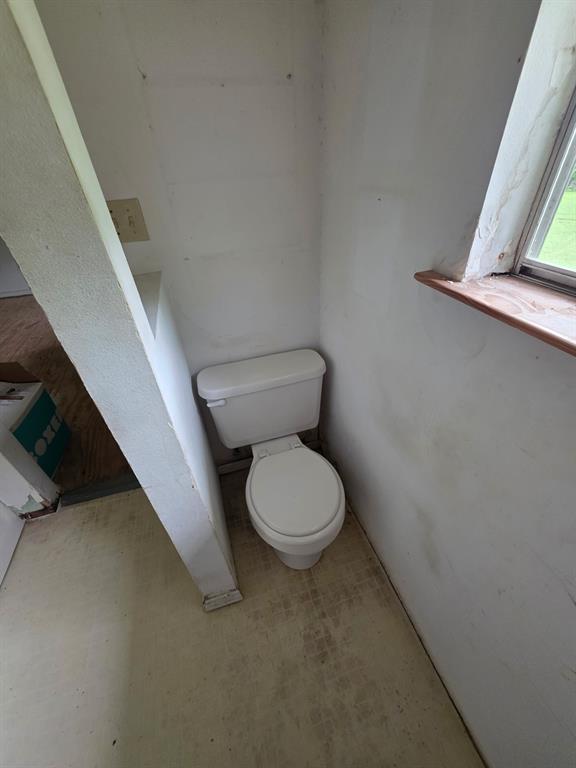 417 West Huffman Street Krum, TX 76249 - Photo 9 of 26 White ceramic toilet with a round bowl