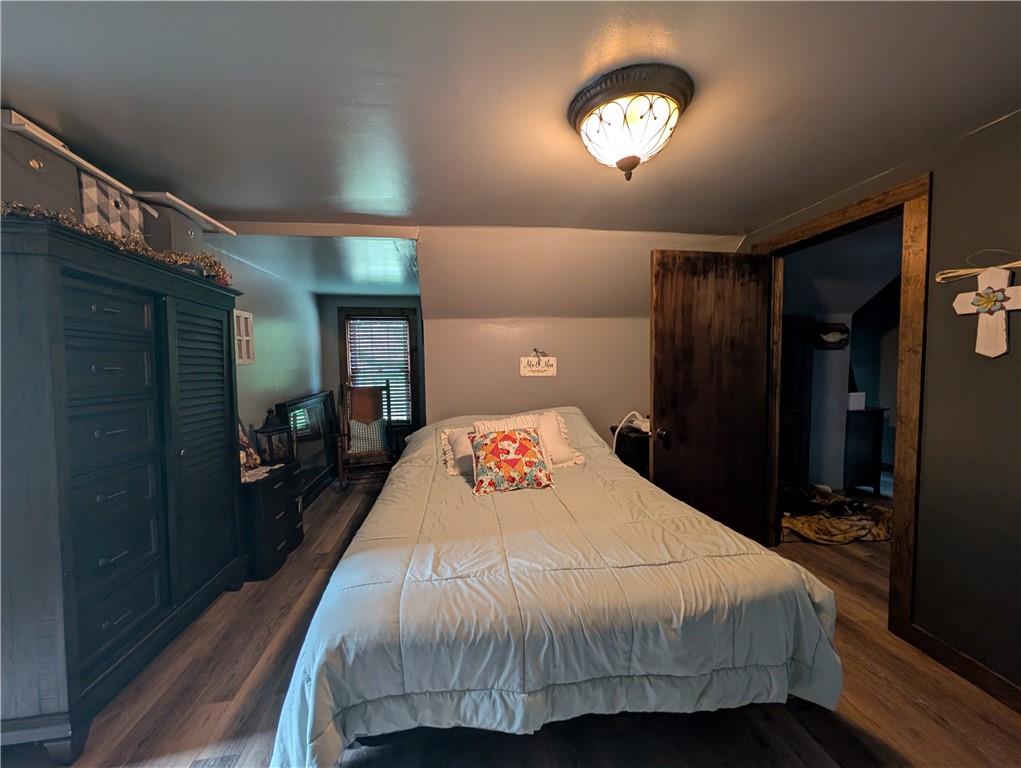 205 Woods Road Ligonier, PA 15658 - Photo 12 of 32 a bedroom with a bed and a chandelier