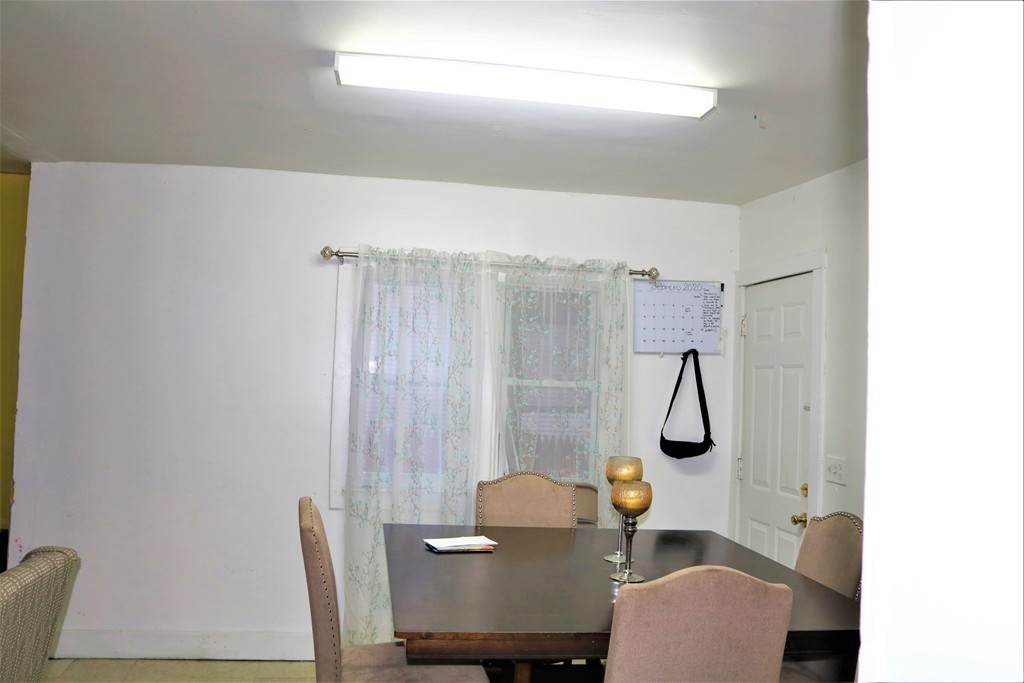 68-70 Appleton Street Springfield, MA 01108 - Photo 16 of 28 a view of a dining room with furniture a chandelier and a window