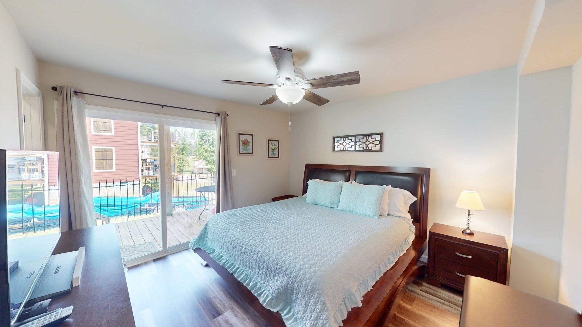 55 Bogey Loop Counce, TN 38326 - Photo 13 of 32 a bedroom with a large bed and a large window