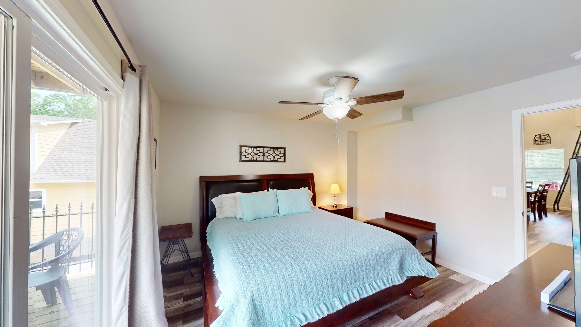 55 Bogey Loop Counce, TN 38326 - Photo 15 of 32 a bedroom with a bed and a chandelier