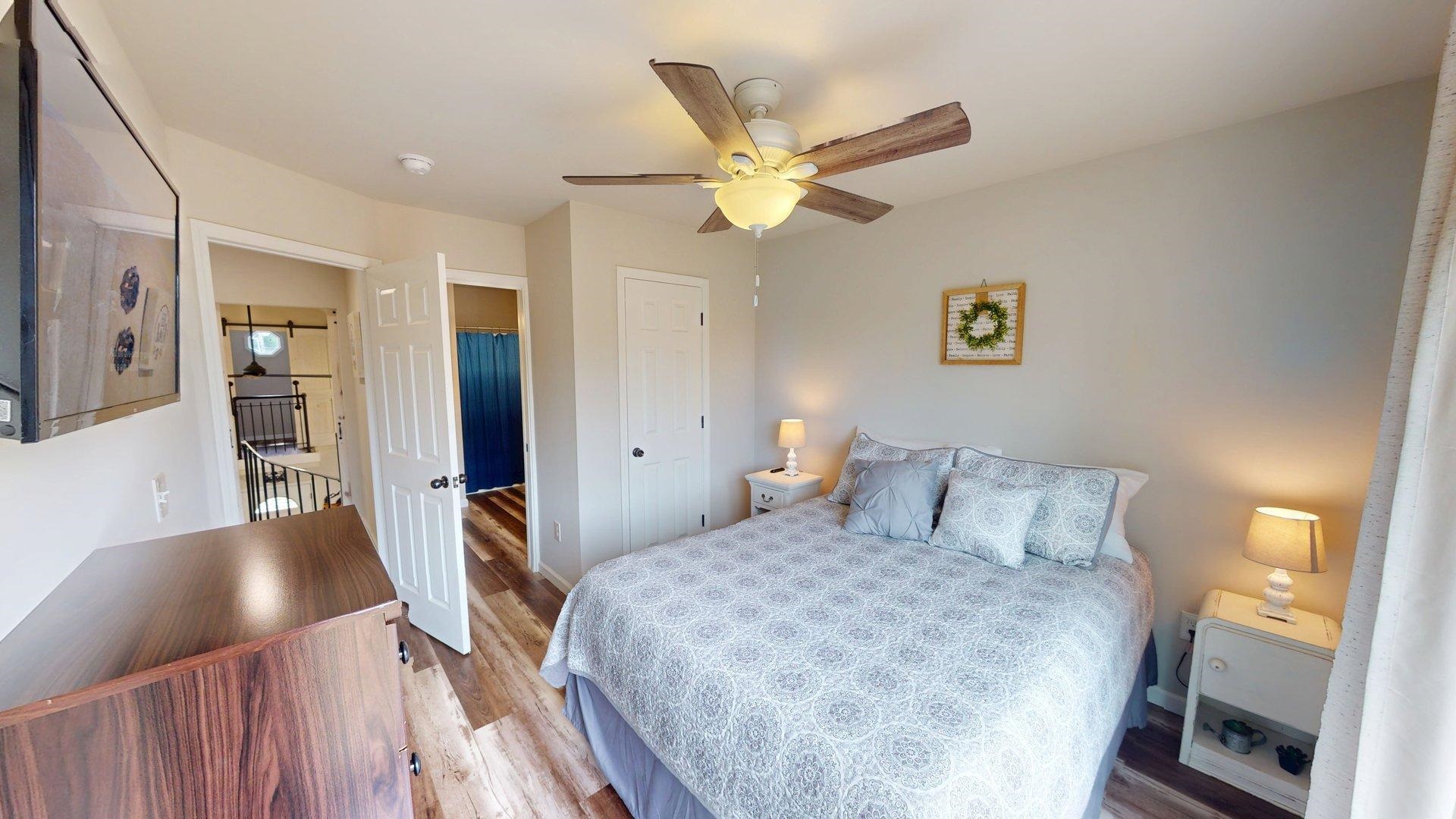 55 Bogey Loop Counce, TN 38326 - Photo 19 of 32 a bedroom with a bed and a chandelier