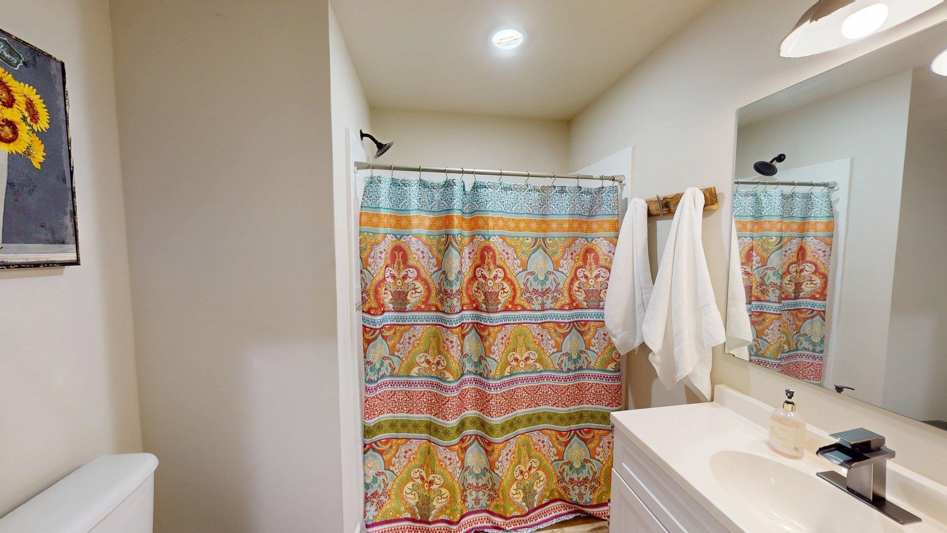 55 Bogey Loop Counce, TN 38326 - Photo 20 of 32 a bathroom with a sink and a shower curtain