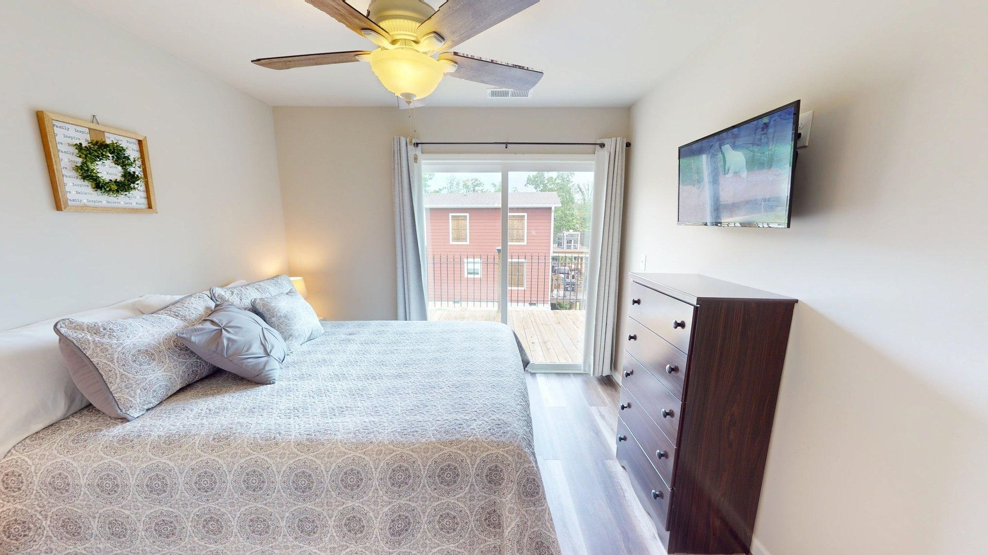 55 Bogey Loop Counce, TN 38326 - Photo 21 of 32 a bedroom with a bed and a flat screen tv