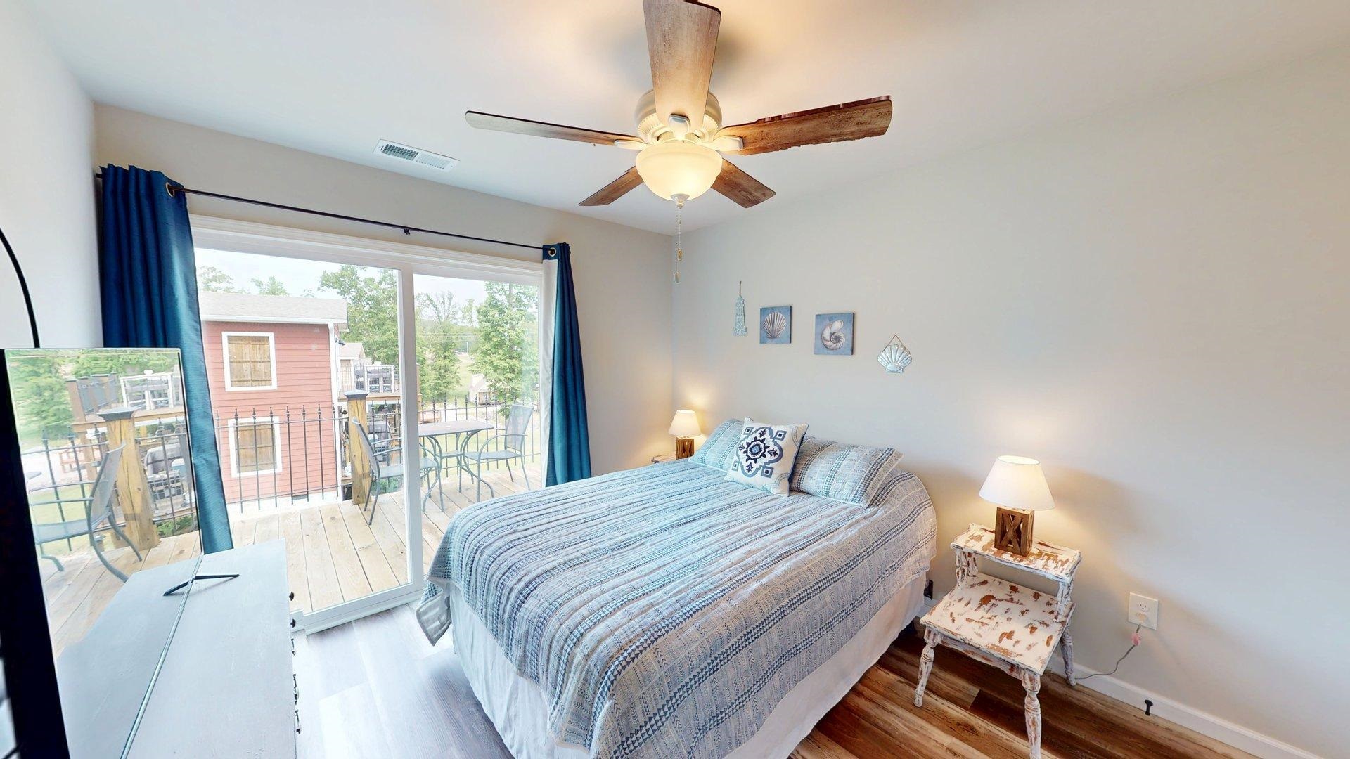 55 Bogey Loop Counce, TN 38326 - Photo 25 of 32 a bedroom with a bed and a large window