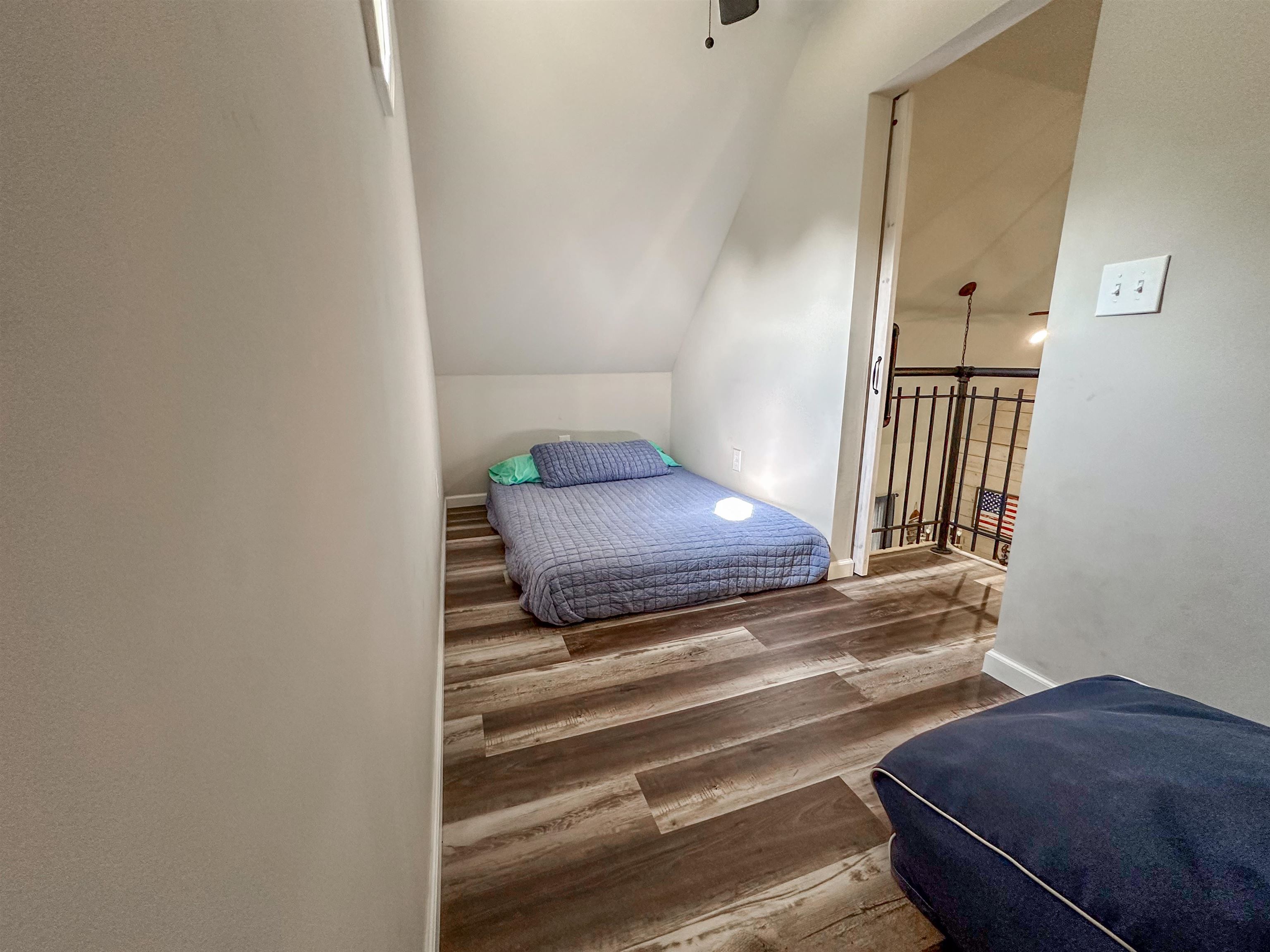 55 Bogey Loop Counce, TN 38326 - Photo 26 of 32 a bedroom with a bed and wooden floor