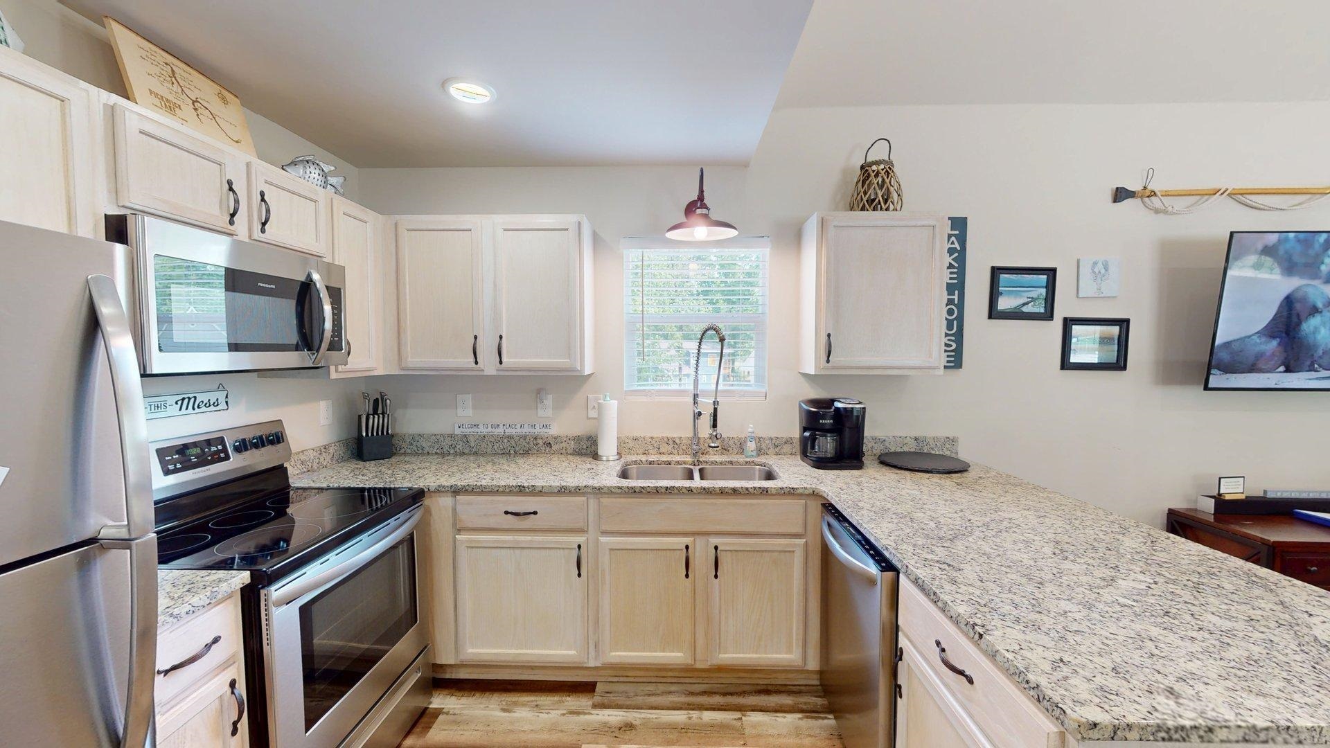 55 Bogey Loop Counce, TN 38326 - Photo 8 of 32 a kitchen with stainless steel appliances granite countertop a sink stove and microwave