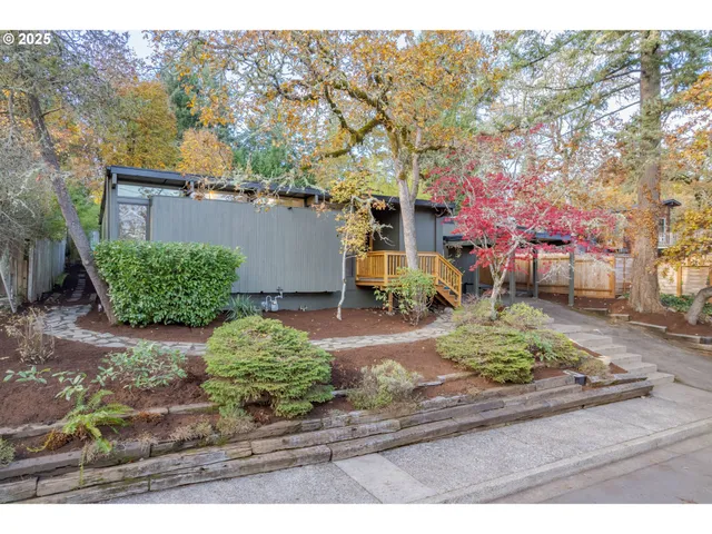 a backyard of a house with a yard and outdoor seating