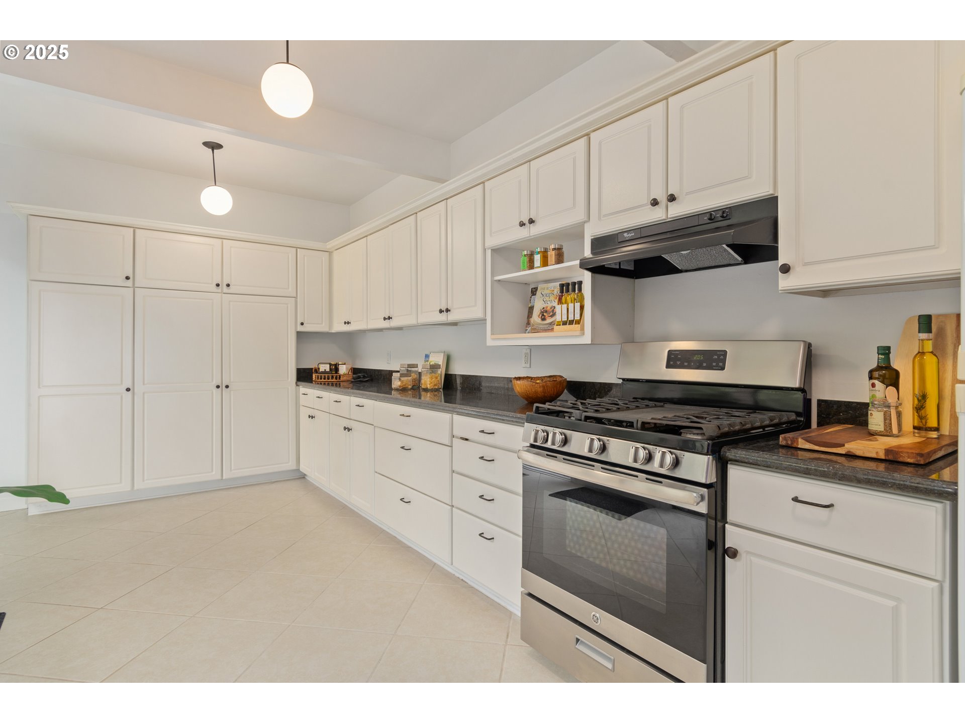 3820 Watkins Lane Eugene, OR 97405 - Photo 21 of 48 a kitchen with stainless steel appliances granite countertop a stove a sink and white cabinets