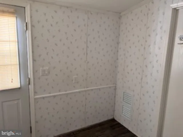 a view of a a dining room with furniture window and wooden floor