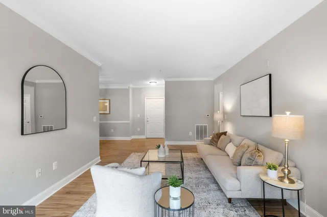 a living room with furniture and a lamp