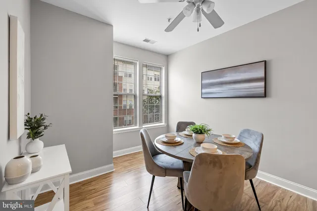 a view of a dining room with furniture window and wooden floor