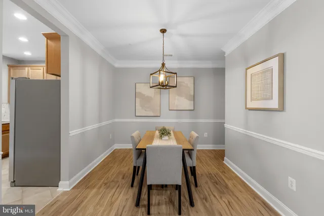 a dining room with furniture and wooden floor