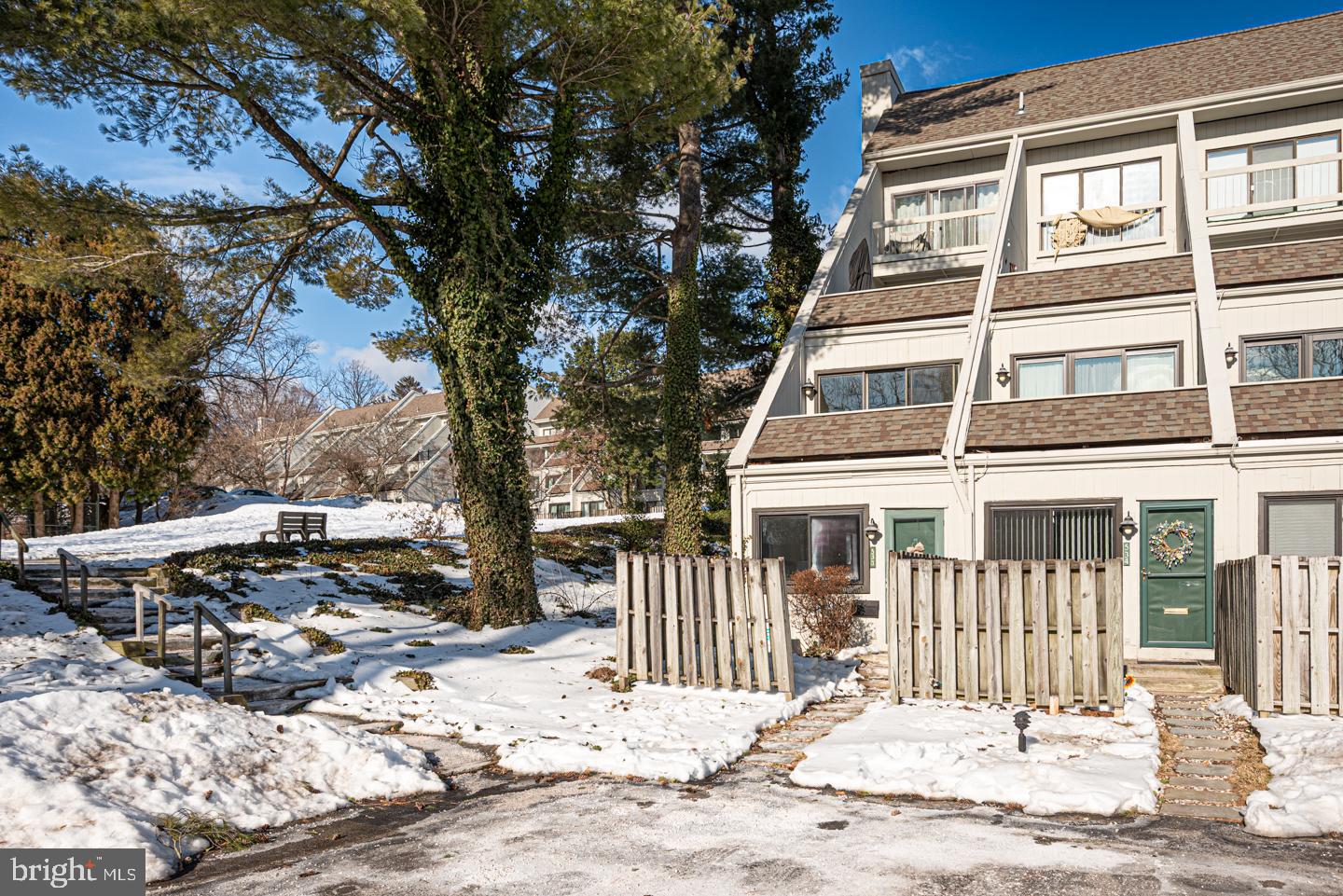 a front view of a house with a tree in the background