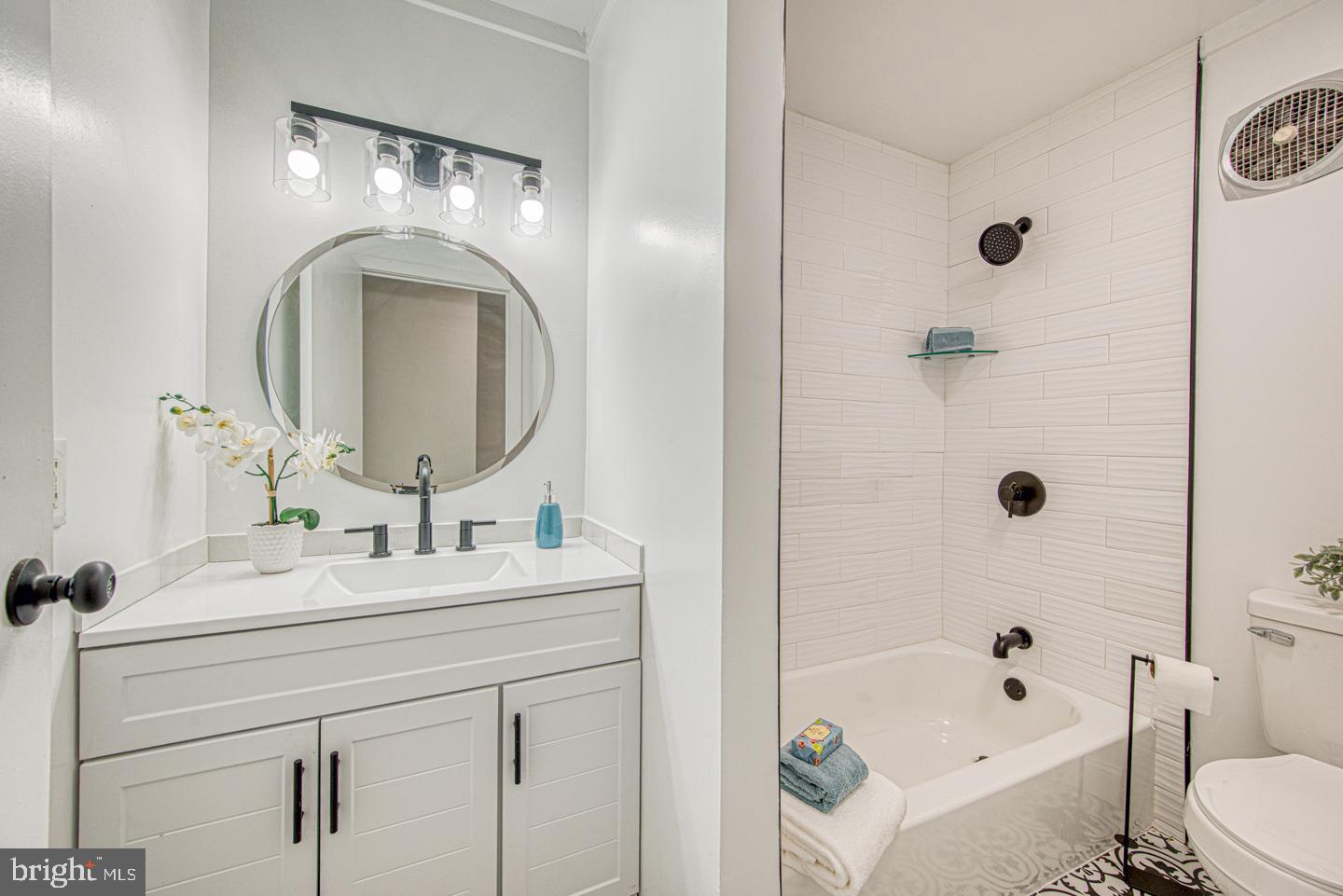 533 Summit House, Unit 533 West Chester, PA 19382 - Photo 15 of 18 a bathroom with a bathtub sink mirror vanity and toilet
