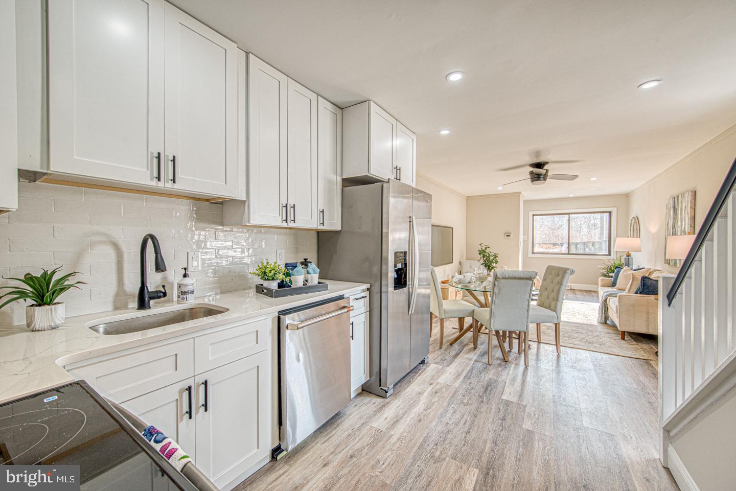 533 Summit House, Unit 533 West Chester, PA 19382 - Photo 7 of 18 a kitchen with white cabinets and wooden floor