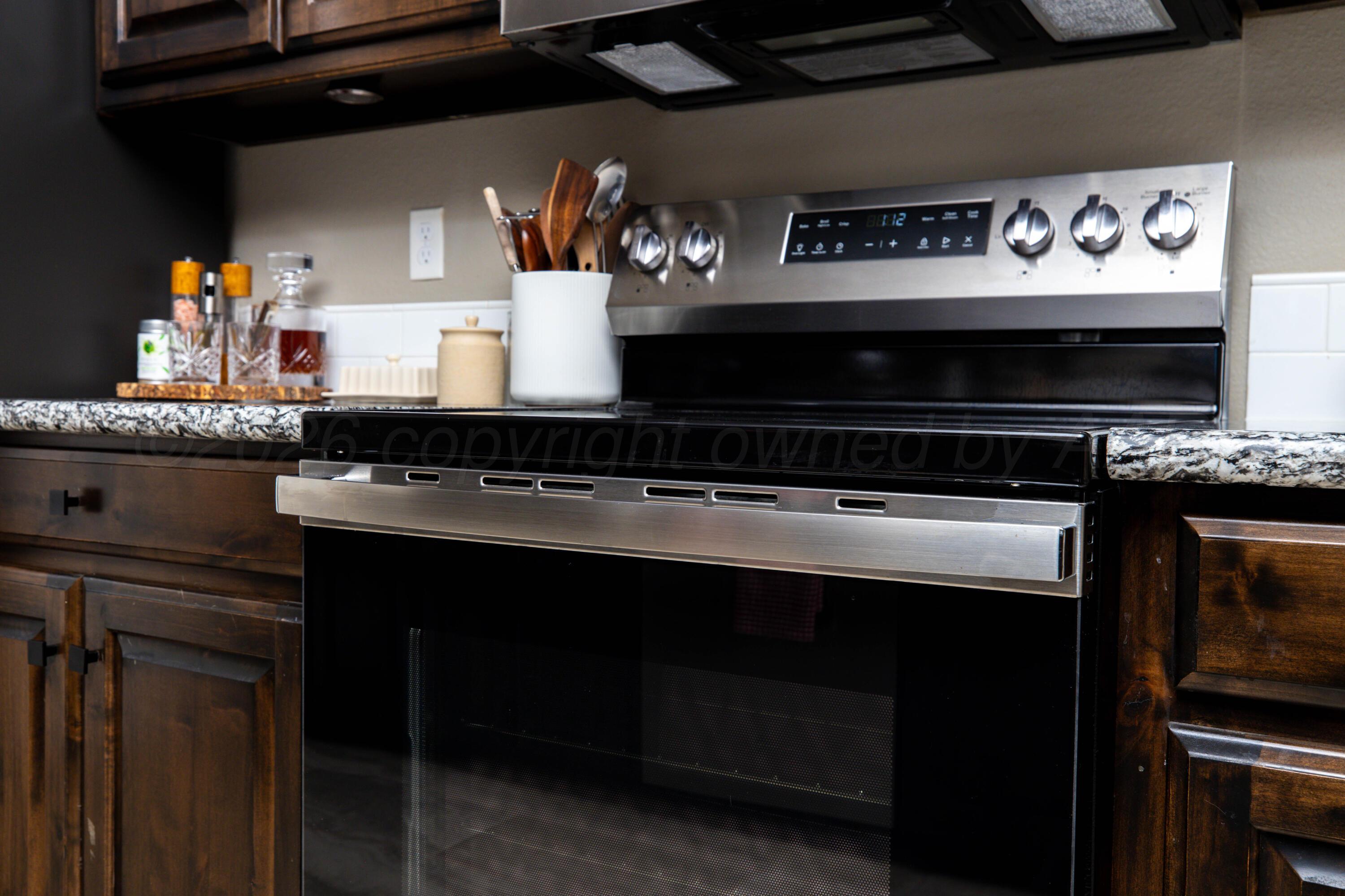 9834 Remington Road Canyon, TX 79015 - Photo 12 of 46 a kitchen with a stove and cabinets