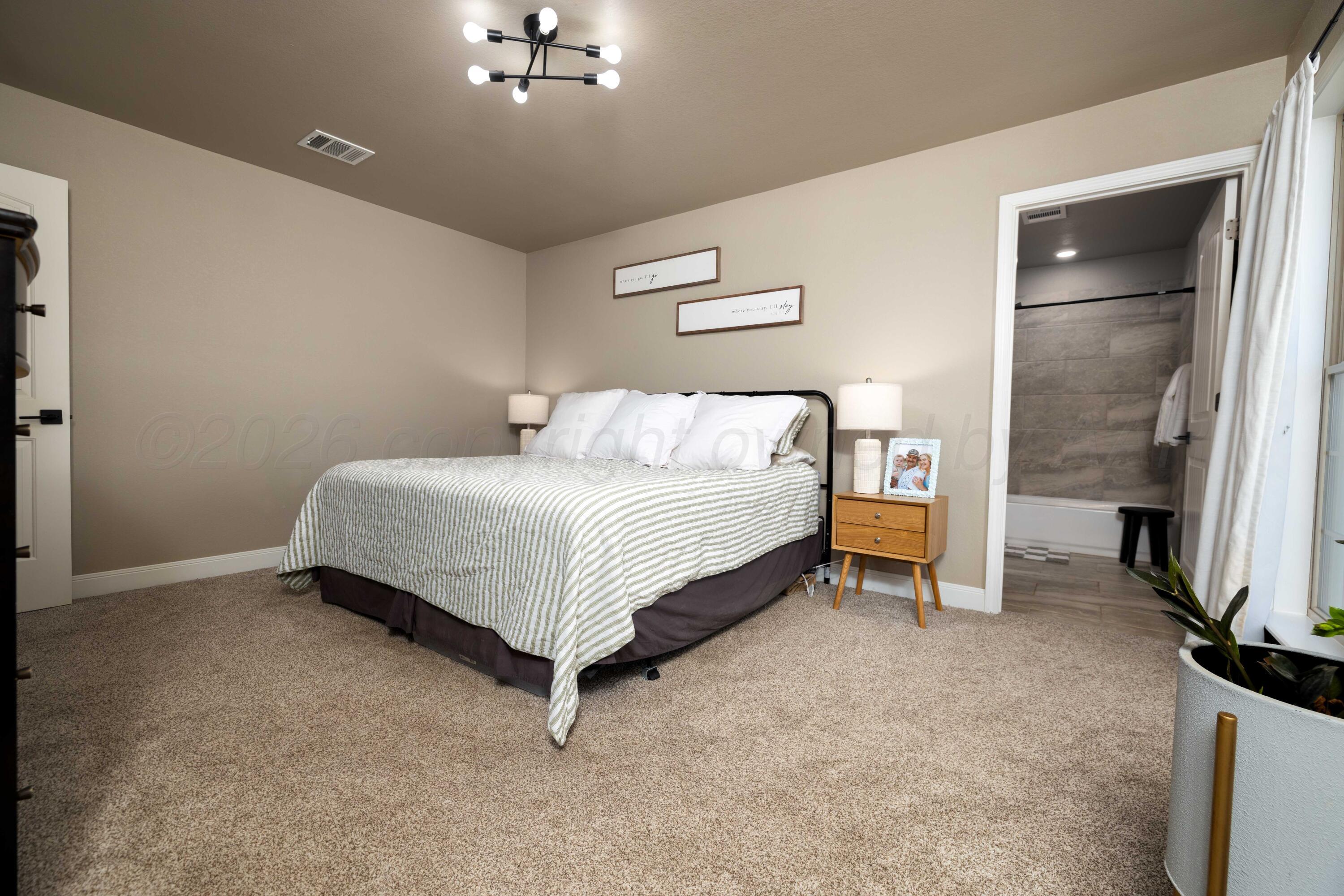 9834 Remington Road Canyon, TX 79015 - Photo 17 of 46 a bedroom with a bed and a table
