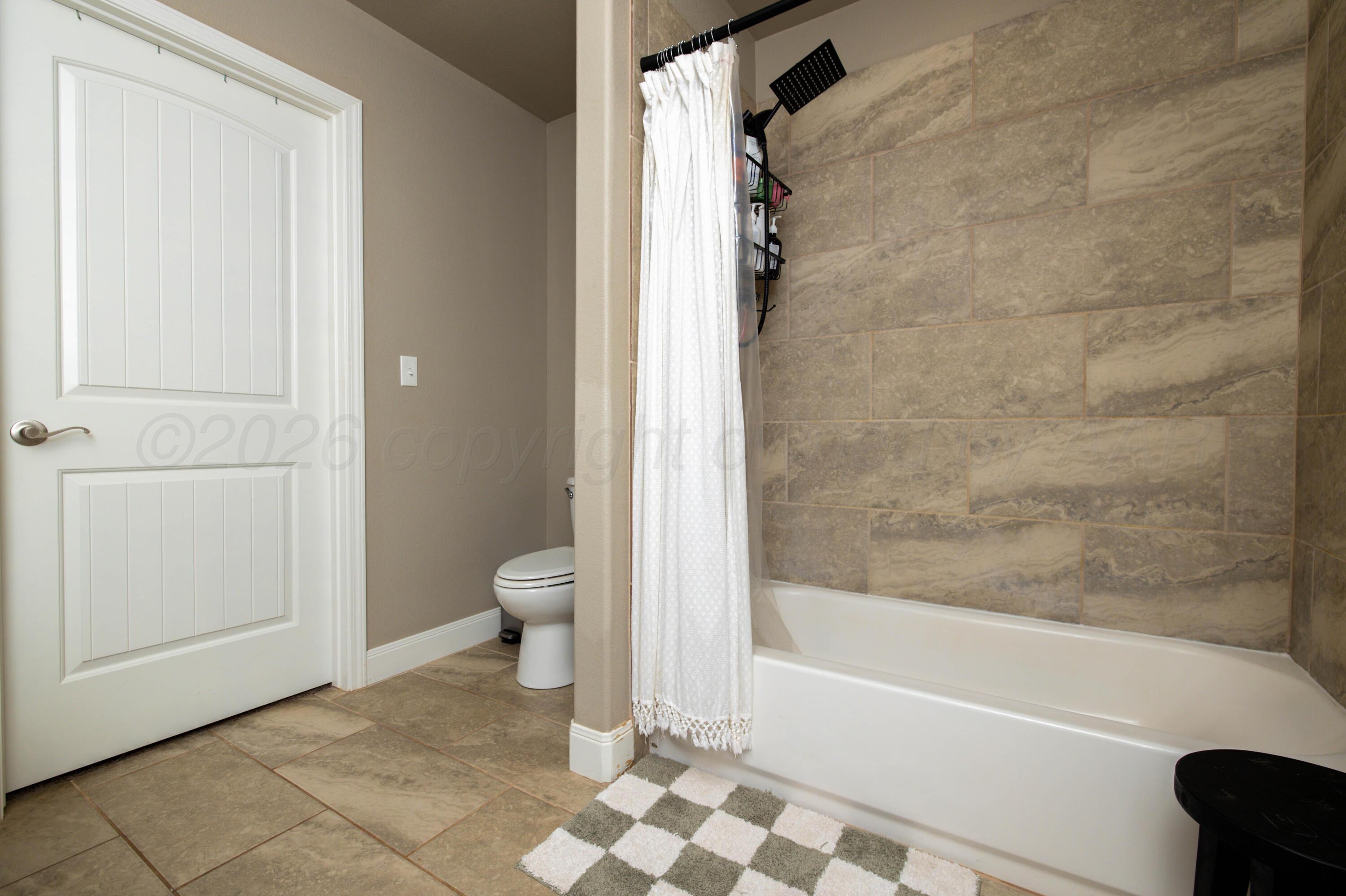9834 Remington Road Canyon, TX 79015 - Photo 19 of 46 a bathroom with a bathtub and a shower