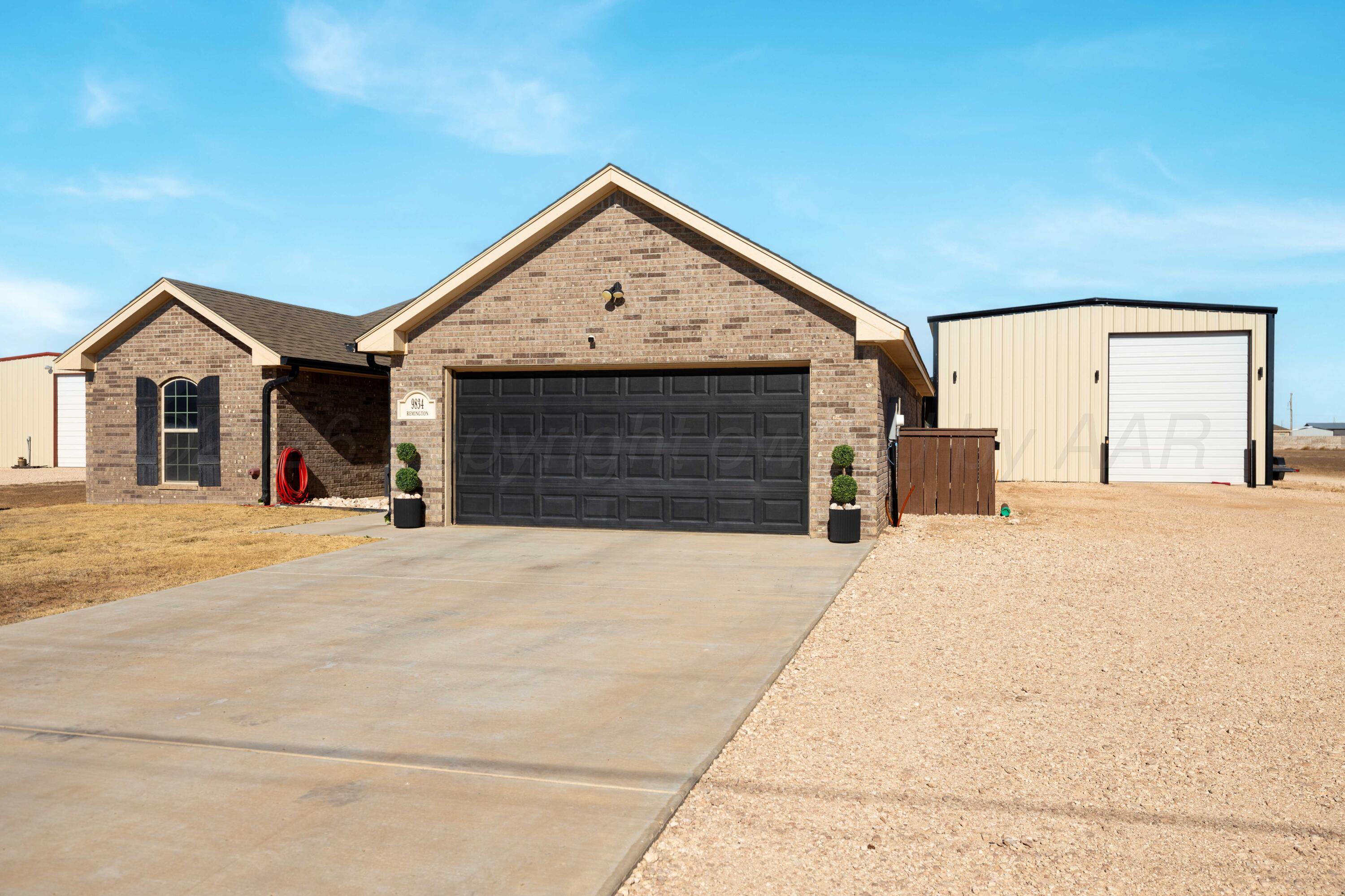 9834 Remington Road Canyon, TX 79015 - Photo 2 of 46 a front view of a house with a yard and garage