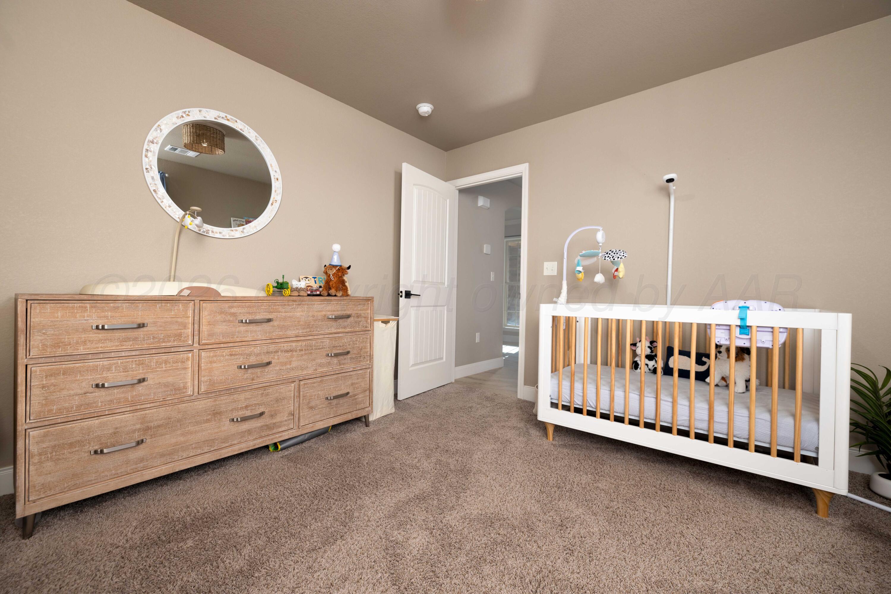 9834 Remington Road Canyon, TX 79015 - Photo 23 of 46 a bedroom with a baby bed and a baby crib