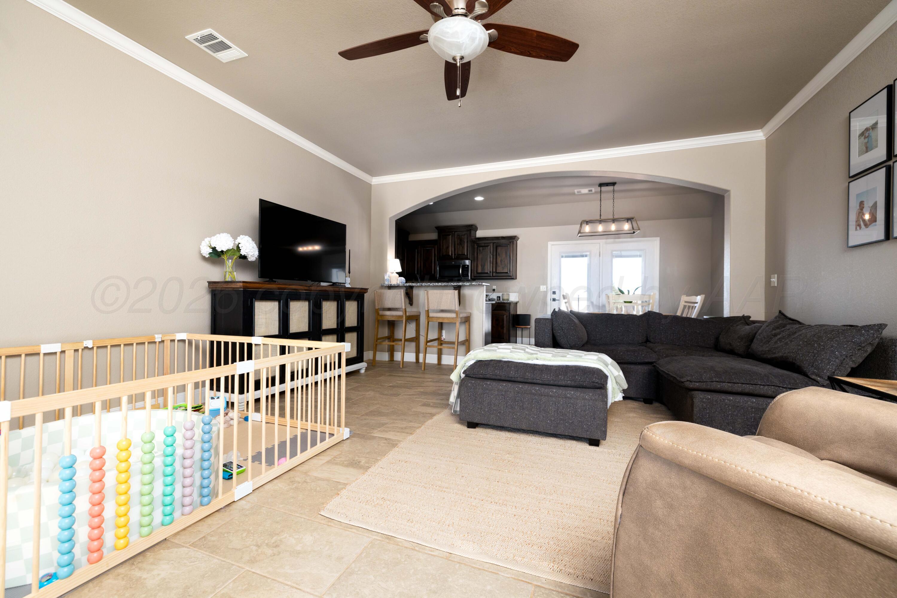 9834 Remington Road Canyon, TX 79015 - Photo 3 of 46 a living room with furniture a flat screen tv and a window
