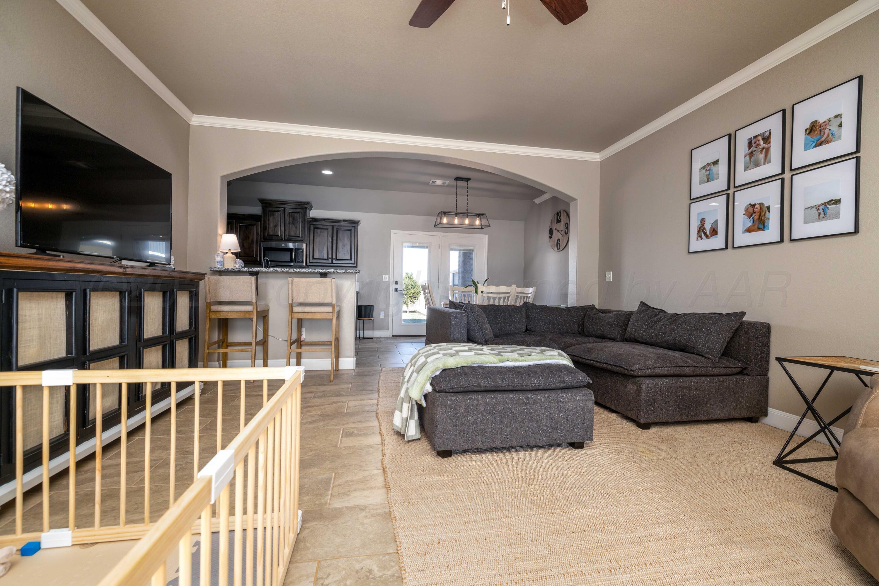 9834 Remington Road Canyon, TX 79015 - Photo 6 of 46 a living room with furniture and a flat screen tv