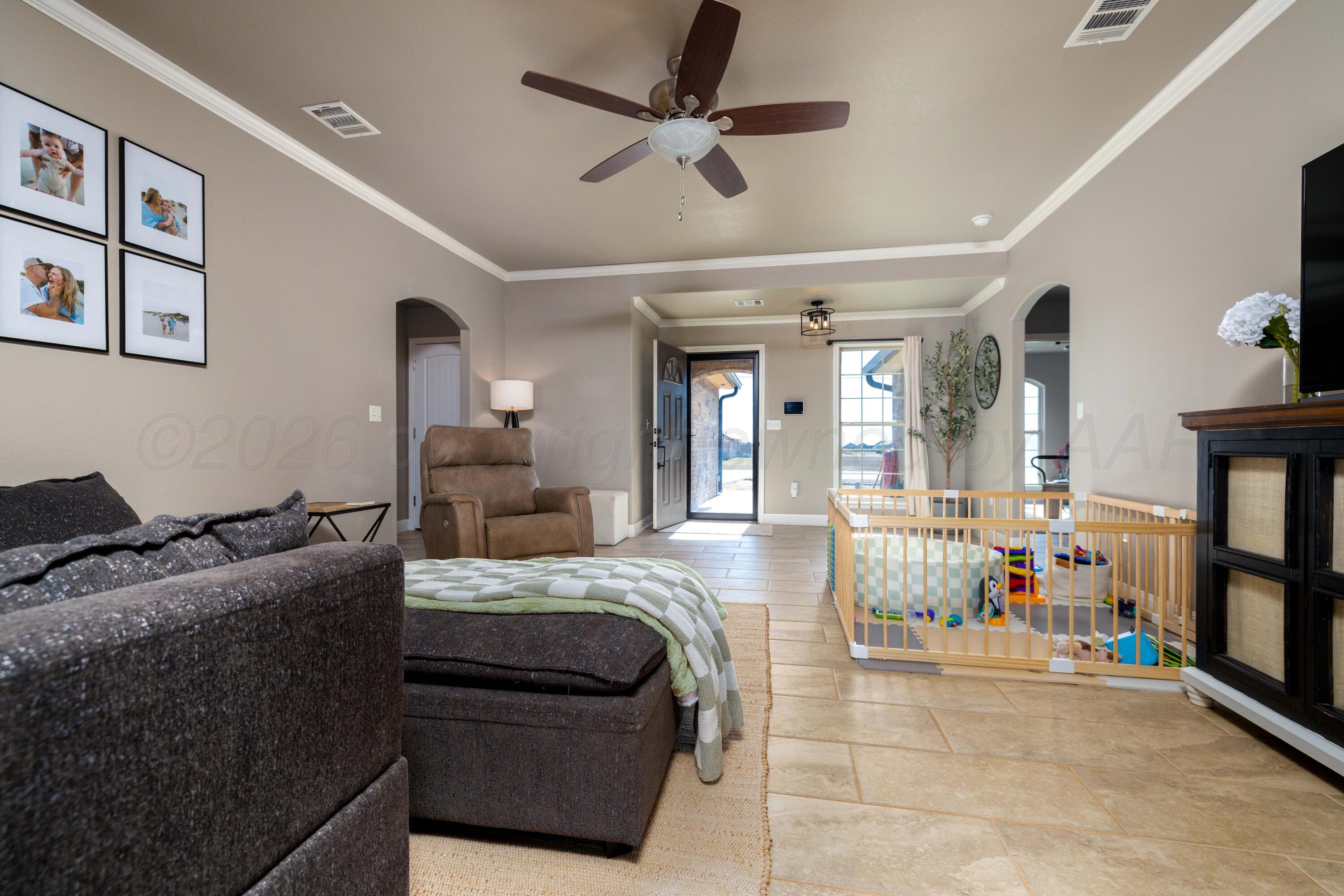 9834 Remington Road Canyon, TX 79015 - Photo 7 of 46 a bedroom with a bed and wooden floor