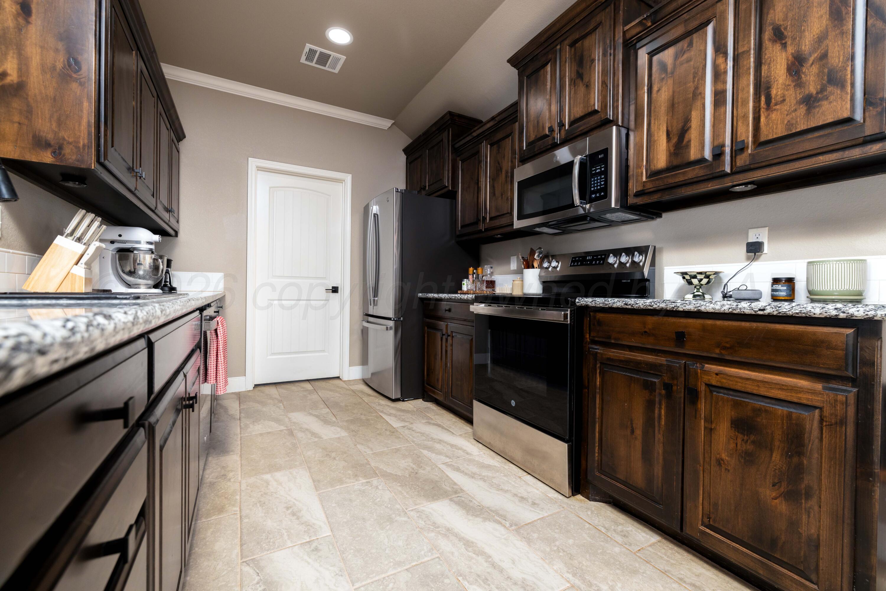 9834 Remington Road Canyon, TX 79015 - Photo 8 of 46 a kitchen with stainless steel appliances granite countertop a stove and a sink