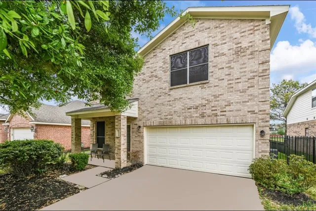 a front view of a house with garage