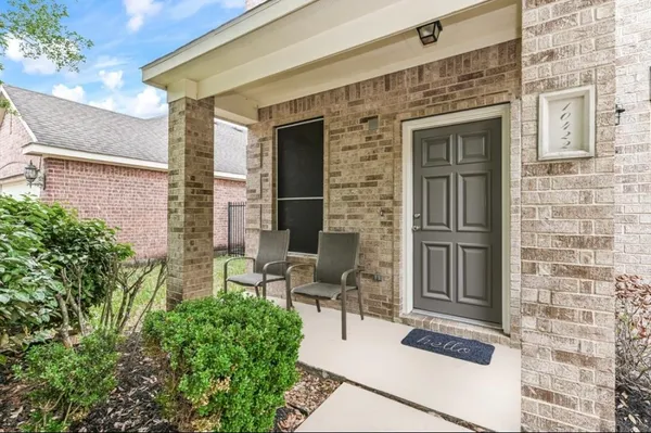 a view of backyard of a house with outdoor seating