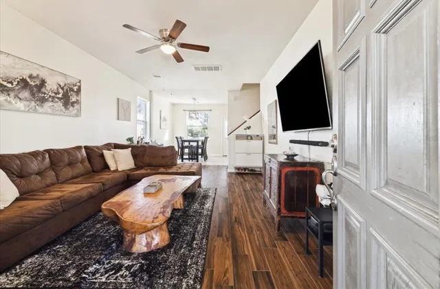 a living room with furniture a flat screen tv and a fireplace