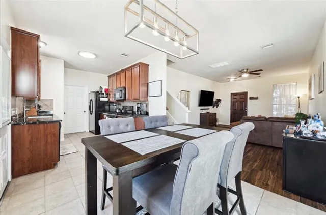 a large kitchen with a table and chairs