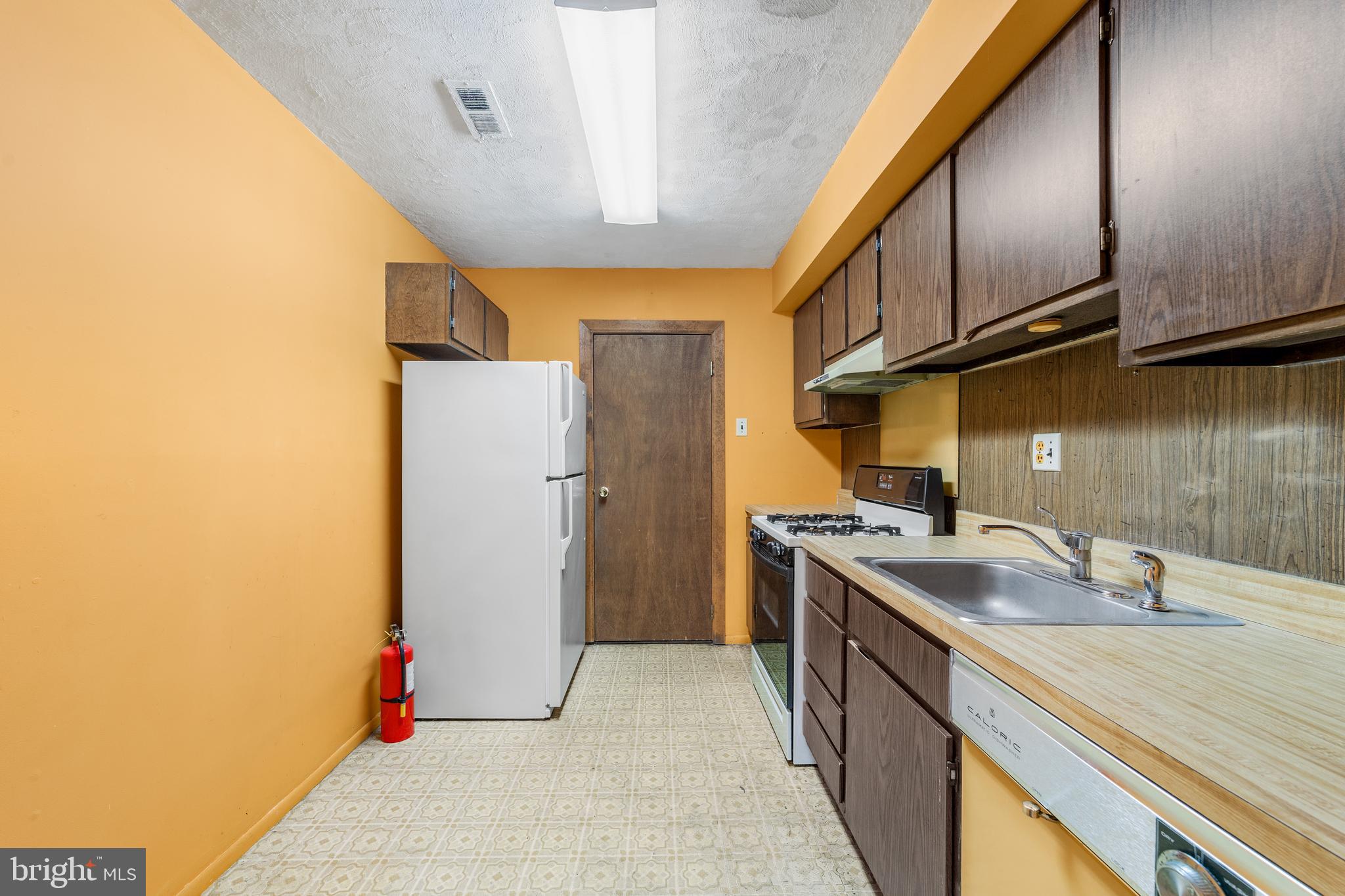 803 Timber Creek Road Clementon, NJ 08021 - Photo 5 of 26 a kitchen with a sink and refrigerator